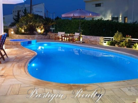 Luxury villa pool illuminated at night in Panorama Voula, Athenian Riviera