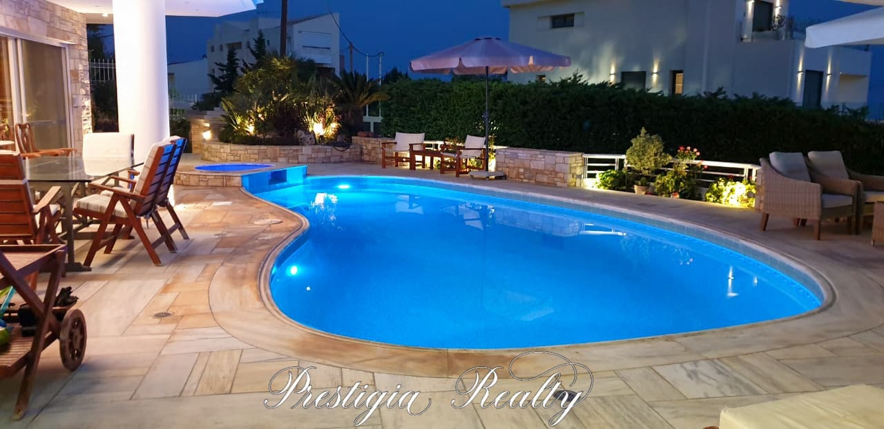 Luxury villa pool illuminated at night in Panorama Voula, Athenian Riviera