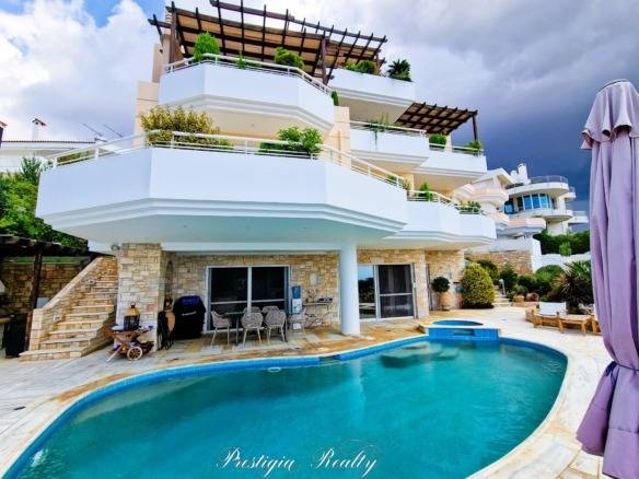 Daytime view of the luxury villa exterior with a private pool in Panorama Voula, Athenian Riviera